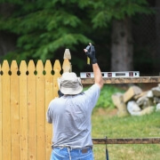 Man installing a physical dog fence