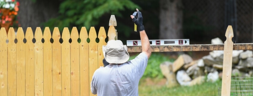 Man installing a physical dog fence