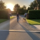 woman showing how to walk dog over the driveway with a dog fence installed
