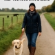 Responsible dog owner walking their dog on a lead in the countryside – compliant with UK dog law
