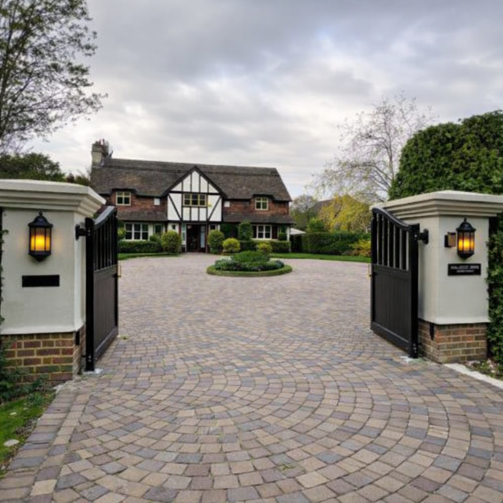 Open Electric Gates and Circular Driveway at Home Counties Property block paved driveway with electric gates showing where invisible dog fence cable can be installed across driveway entrance